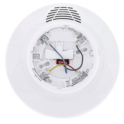 Close-up of a white smoke detector with visible wiring on a white background
