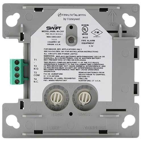 Fire alarm equipment module with label and terminals on a white background