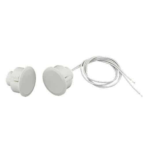 Recessed magnetic window or door security sensor switch on a white background