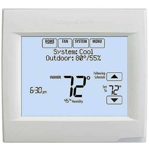 Digital thermostat displaying temperature and system status on a white background