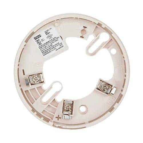 Round metallic component with embedded electronic components on a white background