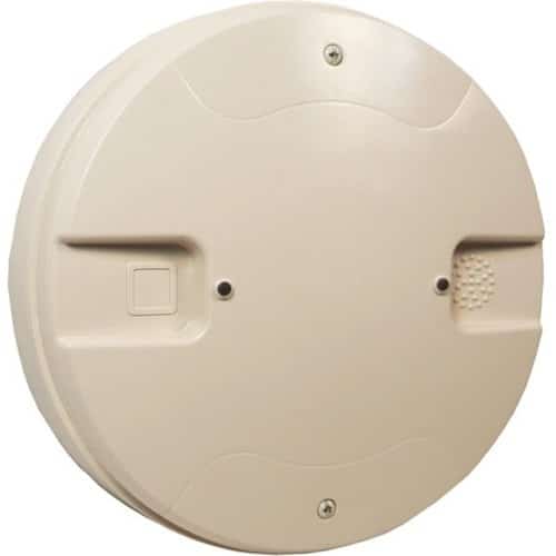 Round beige smoke detector on a white background