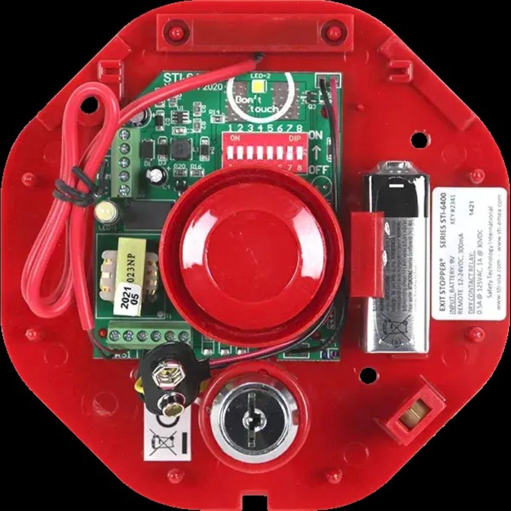 Red electronic device with visible circuit board and components on a black background