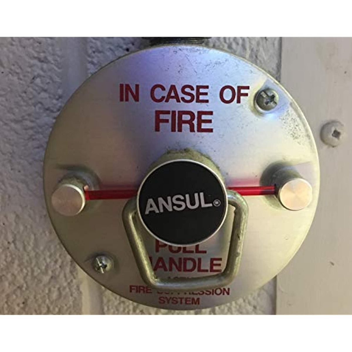 Fire alarm pull station with 'In Case of Fire' label and 'Ansul' branding.