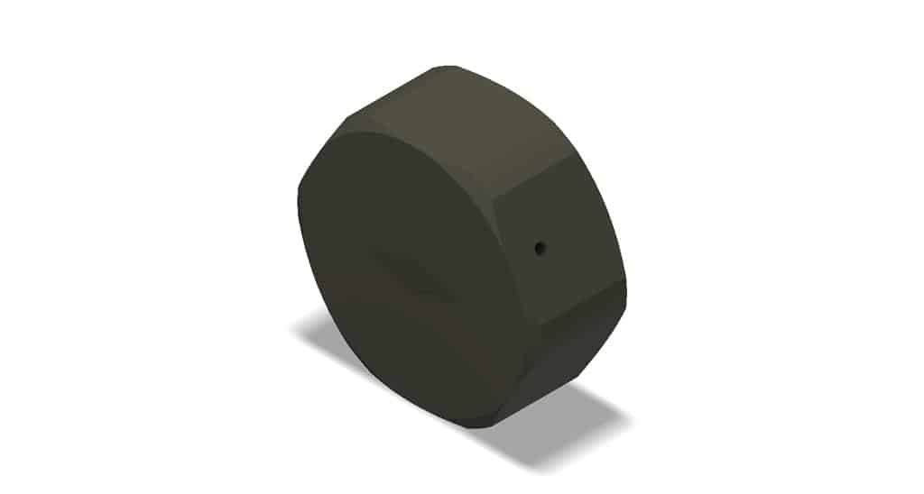 Black circular object with a small hole on a white background