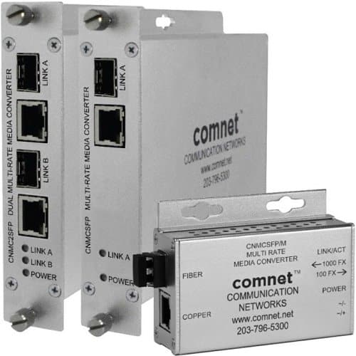 Two Comnet communication network media converters on a white background
