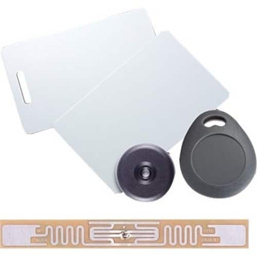 RFID tag, label, and small round device on a white background