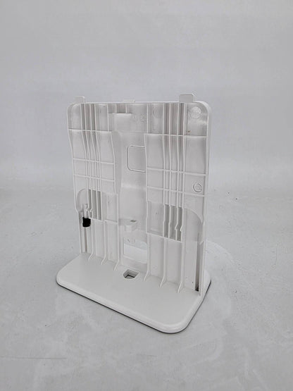 A white device stand with multiple vertical and horizontal slots, shown on a light gray background.