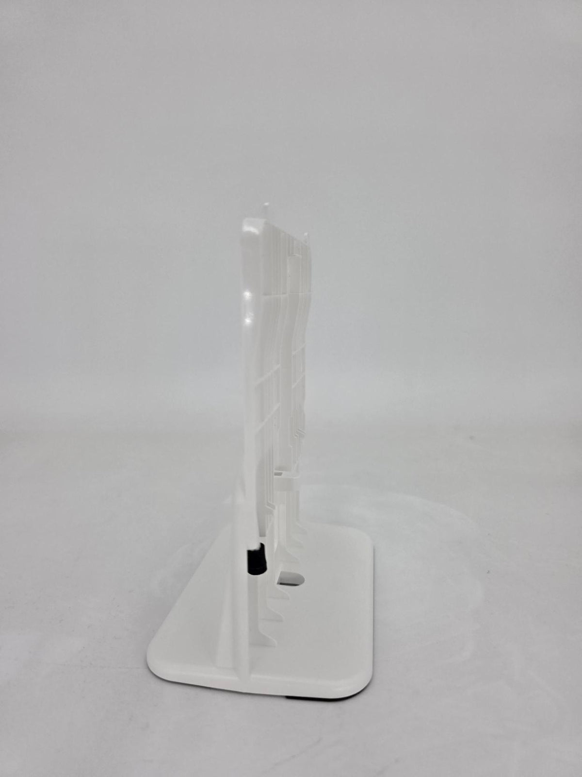 A white plastic display stand with a rectangular base and a vertical acrylic panel, shown on a light gray background.