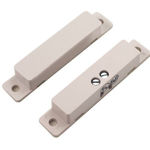 Two beige magnetic door closers on a white background